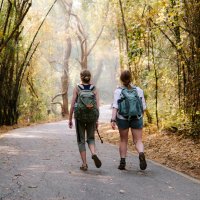 Heather Bortolussi and Fay Paicos walking on wooded street in Thailand